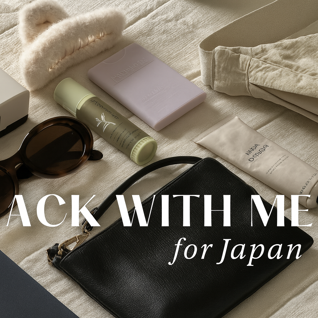 “A flatlay of minimalist winter travel essentials for a Japan trip, including sunglasses, pouch, skincare items, and accessories.”