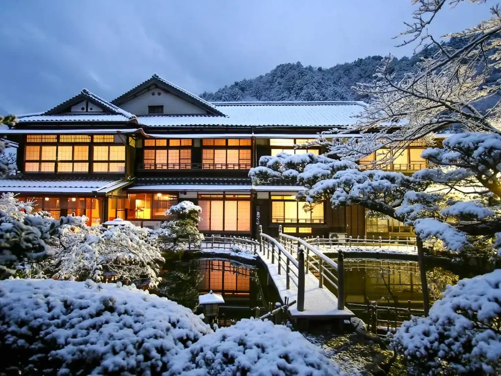 “Night view of Osaka city with luxury hotels and New Year countdown atmosphere, showcasing winter travel accommodations in Japan.”