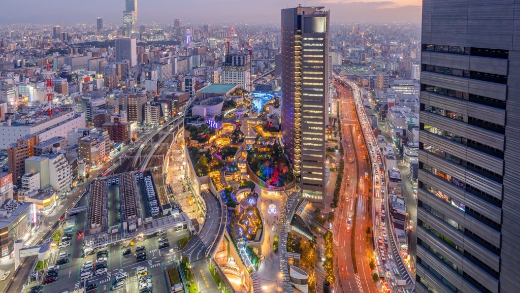 Night view of Osaka’s Namba and Shinsaibashi area with bright neon lights, hotel buildings, and vibrant city streets.